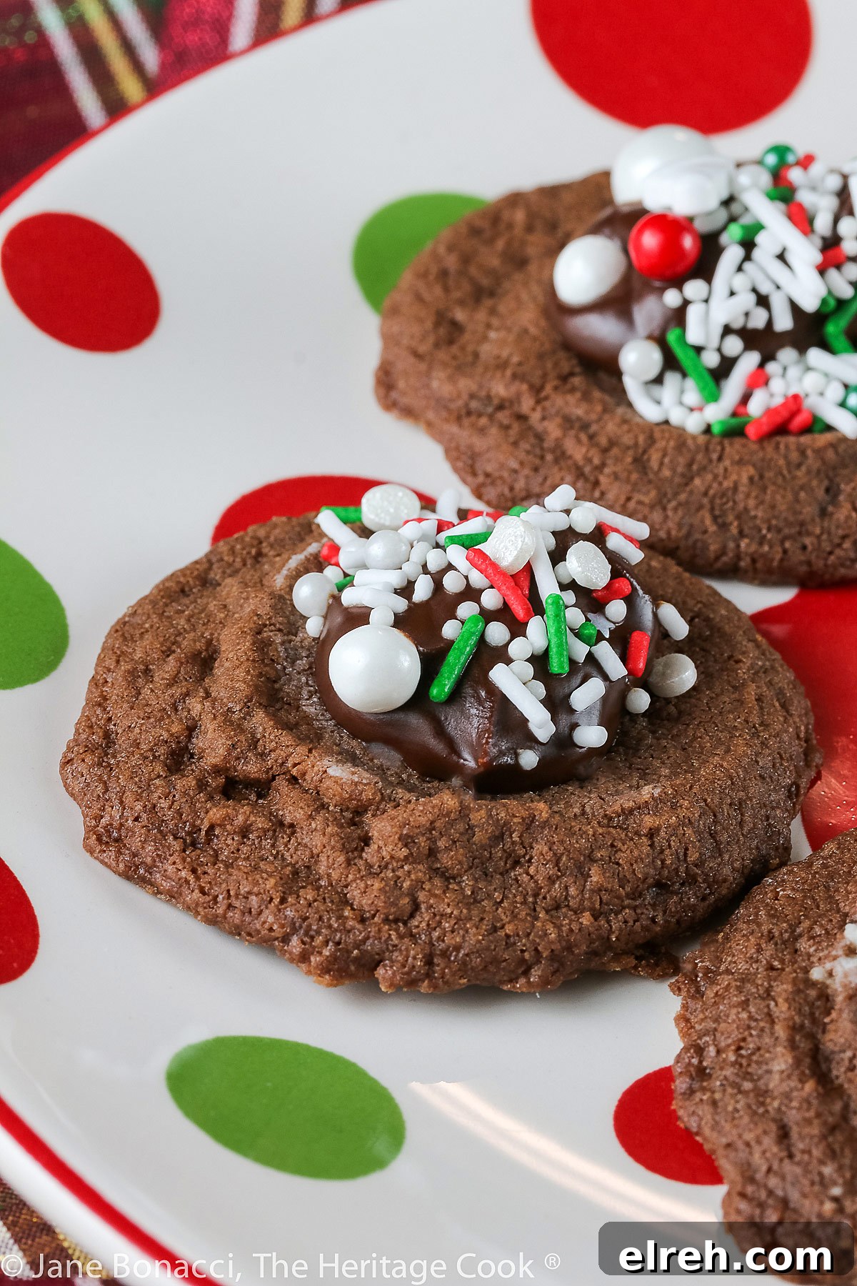 Small cookie cups filled with mint chocolate ganache and topped with festive holiday sprinkles; Hot Chocolate Mint Thumbprint Cookies