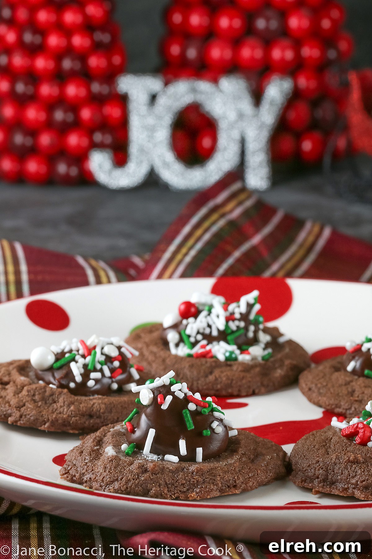 Small cookie cups filled with mint chocolate ganache and topped with festive holiday sprinkles