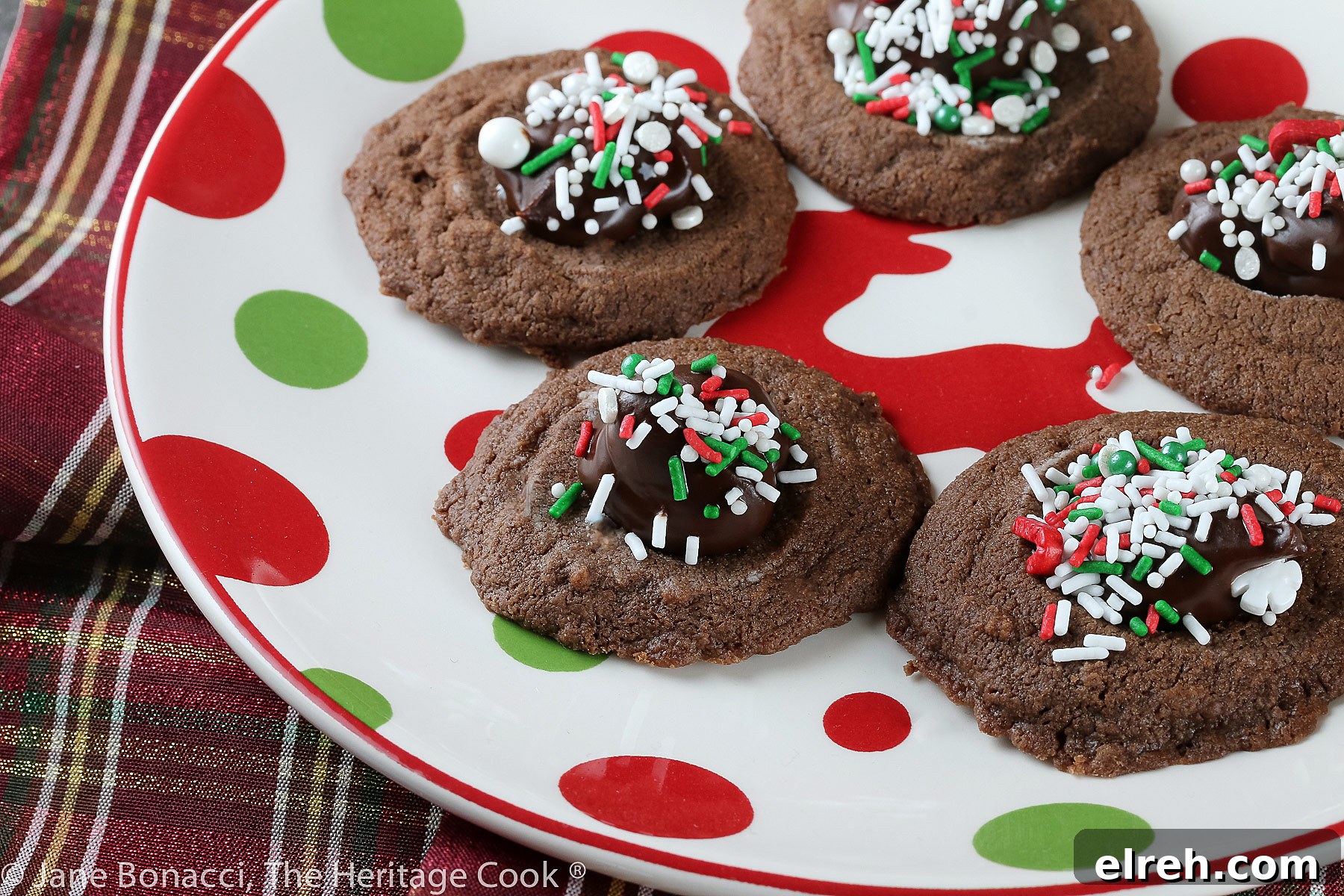 Small cookie cups filled with mint chocolate ganache and topped with festive holiday sprinkles