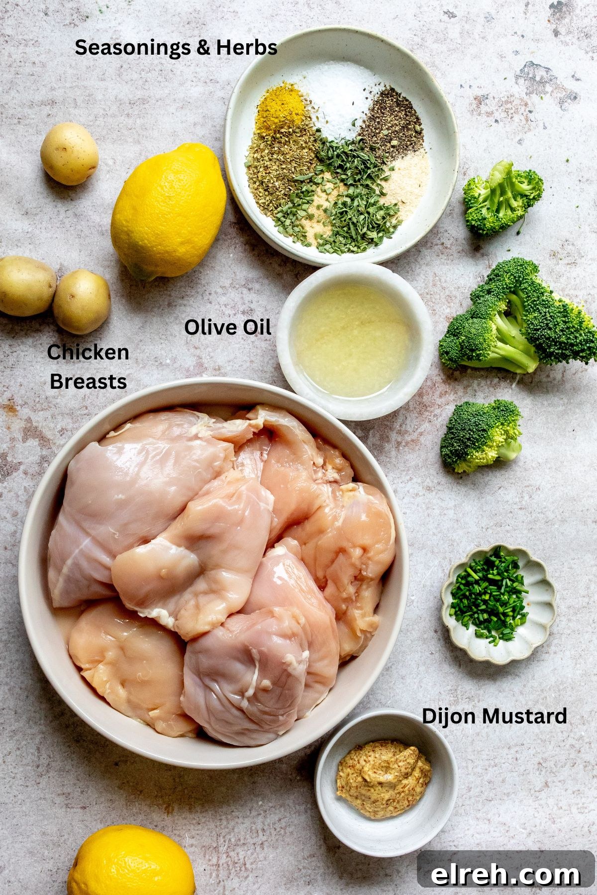 Garlic Lemon Herb Chicken Recipe 3 Ingredients for lemon herb chicken arranged on a counter with small bowls.