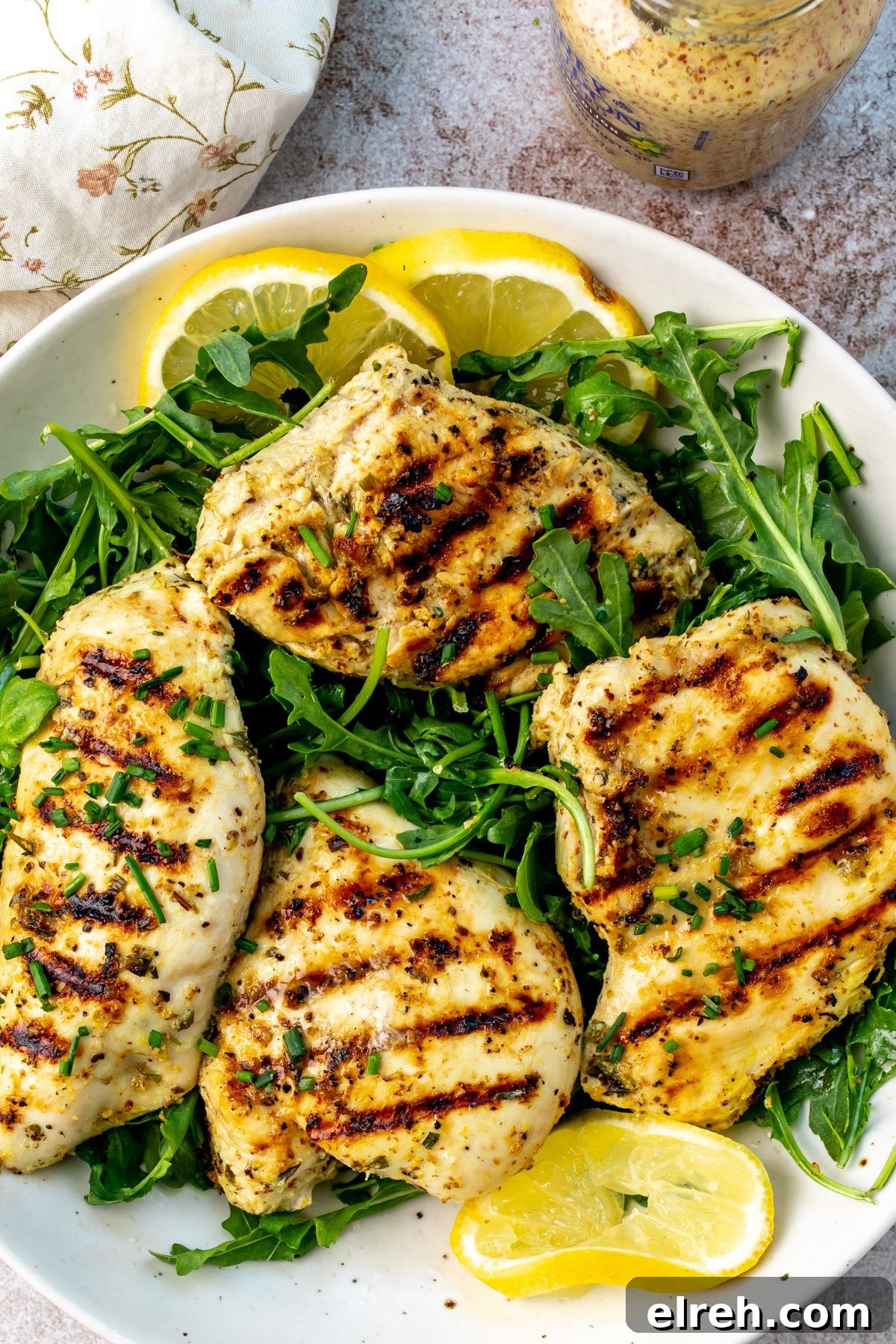 Garlic Lemon Herb Chicken Recipe 5 Lemon herb chicken served on a plate with lemon slices.