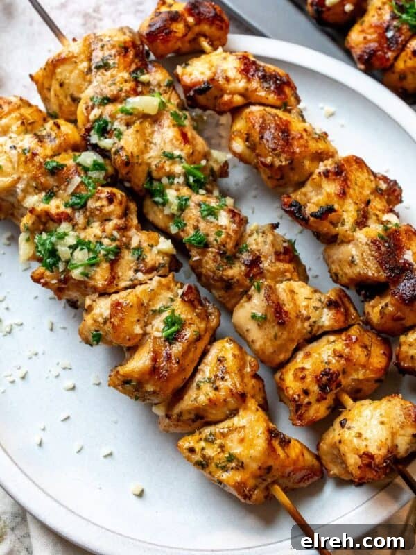 Garlic Lemon Herb Chicken Recipe 8 Garlic Parmesan chicken skewers on a plate.