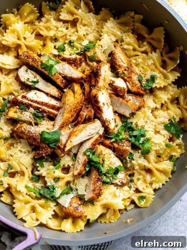 Garlic Lemon Herb Chicken Recipe 9 Overhead image of garlic Parmesan chicken pasta in a skillet.