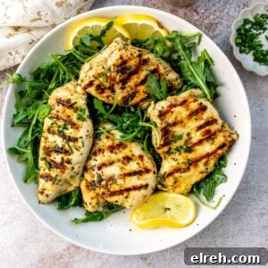 Garlic Lemon Herb Chicken Recipe 10 Lemon herb chicken on a plate with lemons.