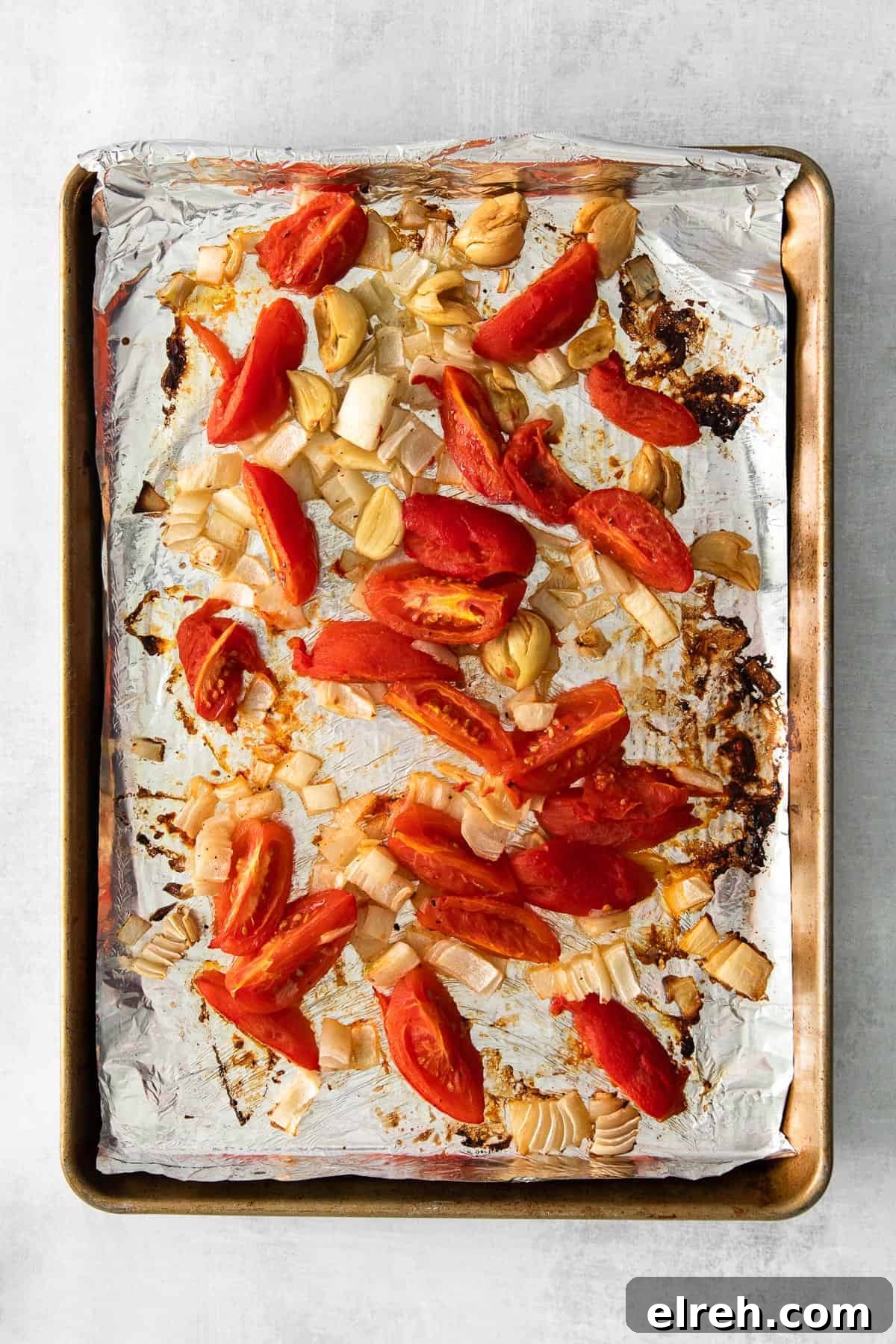 The most delicious creamy vegan pasta is made with soaked cashews, roasted tomatoes, and garlic. Blend it up and serve it with fresh basil and your favorite pasta! roasted veggies on pan