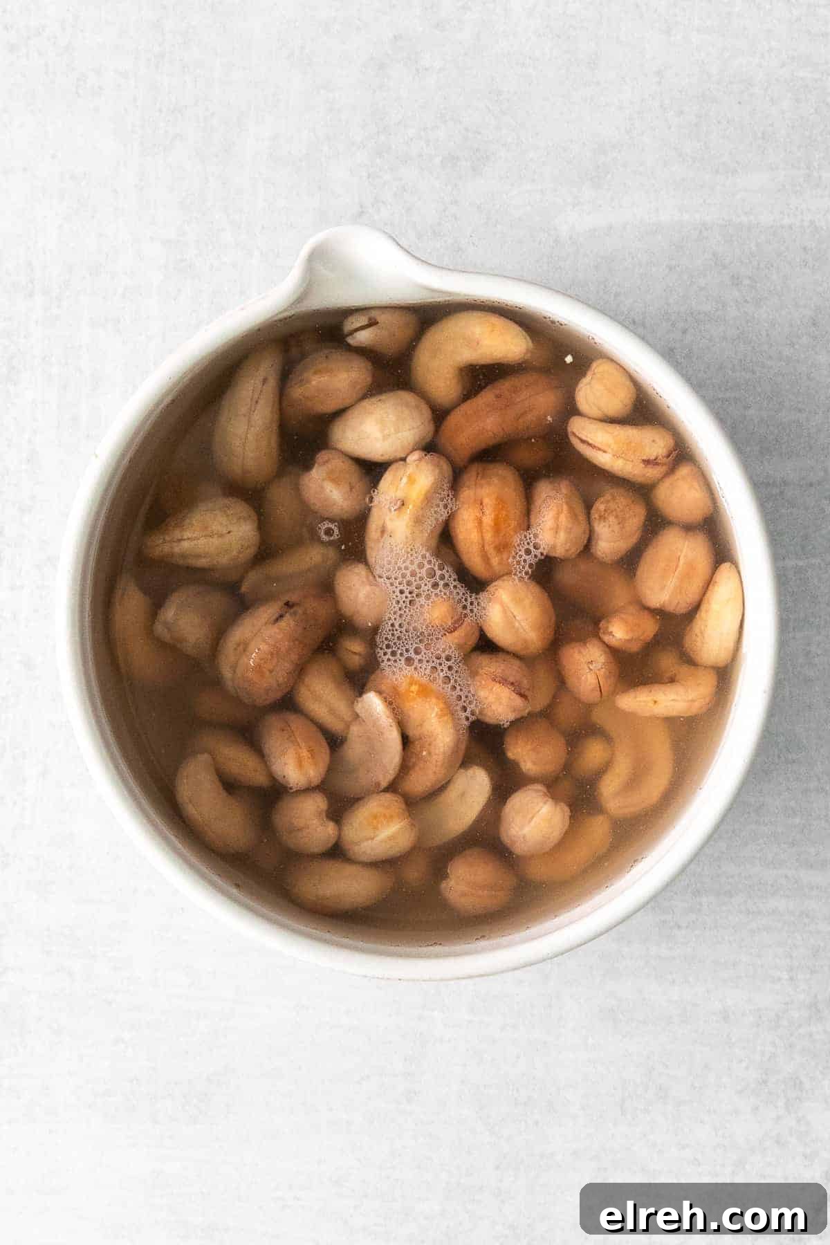The most delicious creamy vegan pasta is made with soaked cashews, roasted tomatoes, and garlic. Blend it up and serve it with fresh basil and your favorite pasta! raw cashews soaking in water