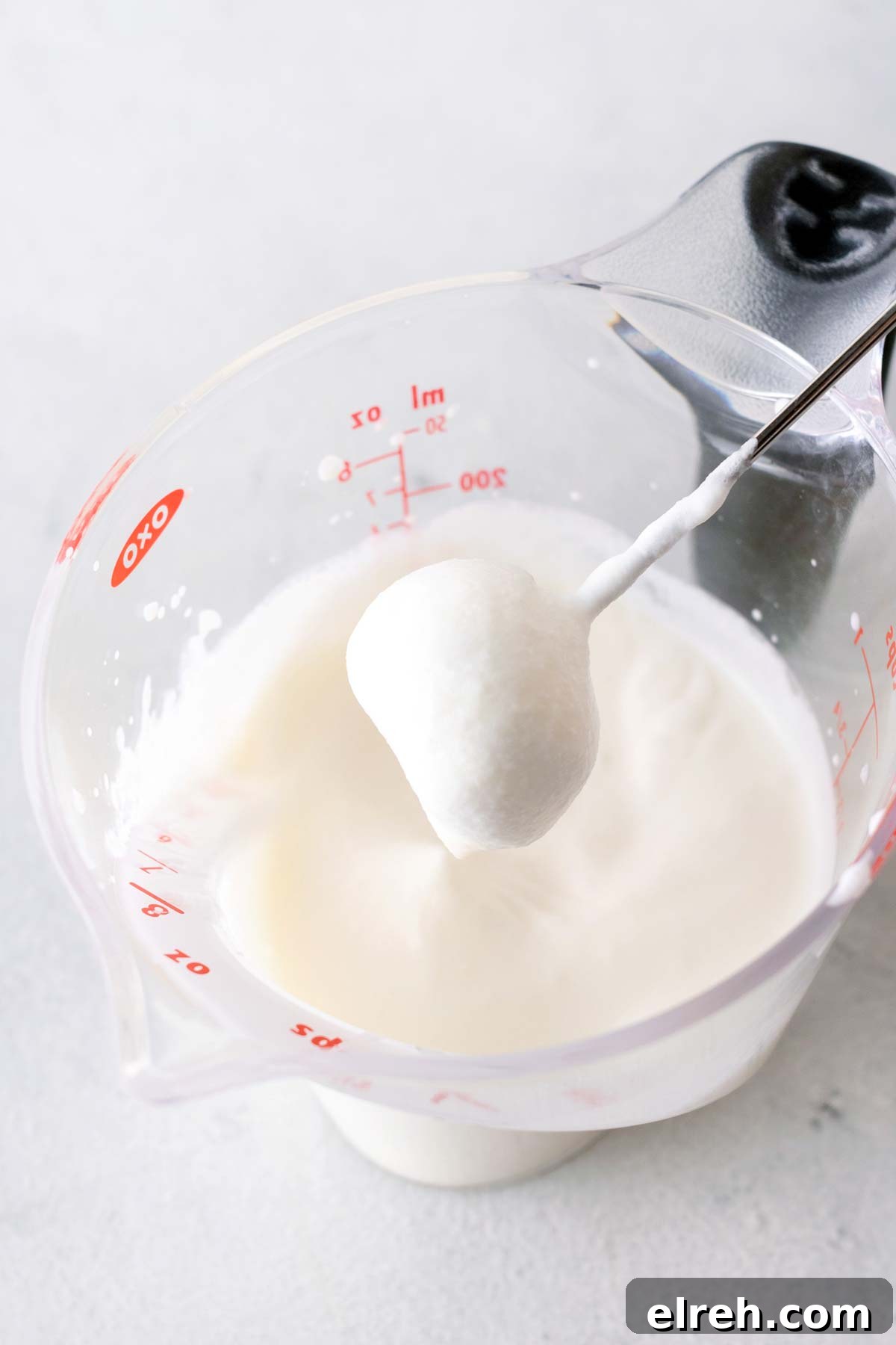 Vanilla Bean Frappuccino Starbucks Copycat Recipe 5 Whipped cream in a measuring cup.