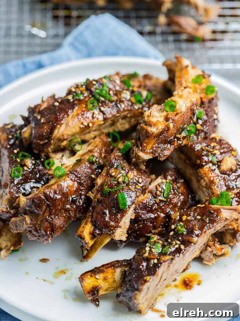 Instant Pot Asian Ribs on a white plate garnished with scallions