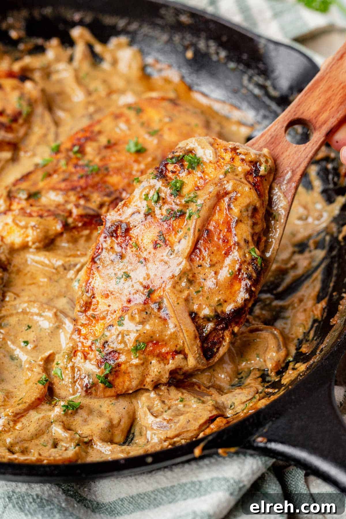 spatula scooping Boursin chicken out of a skillet