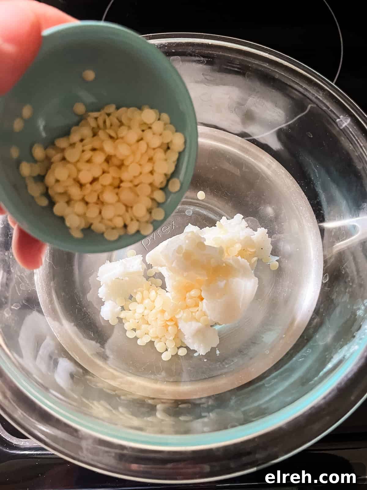 How to Make Tallow Lip Balm for Soft, Hydrated Lips 4 Pouring beeswax pellets into a double boiler with melting tallow.