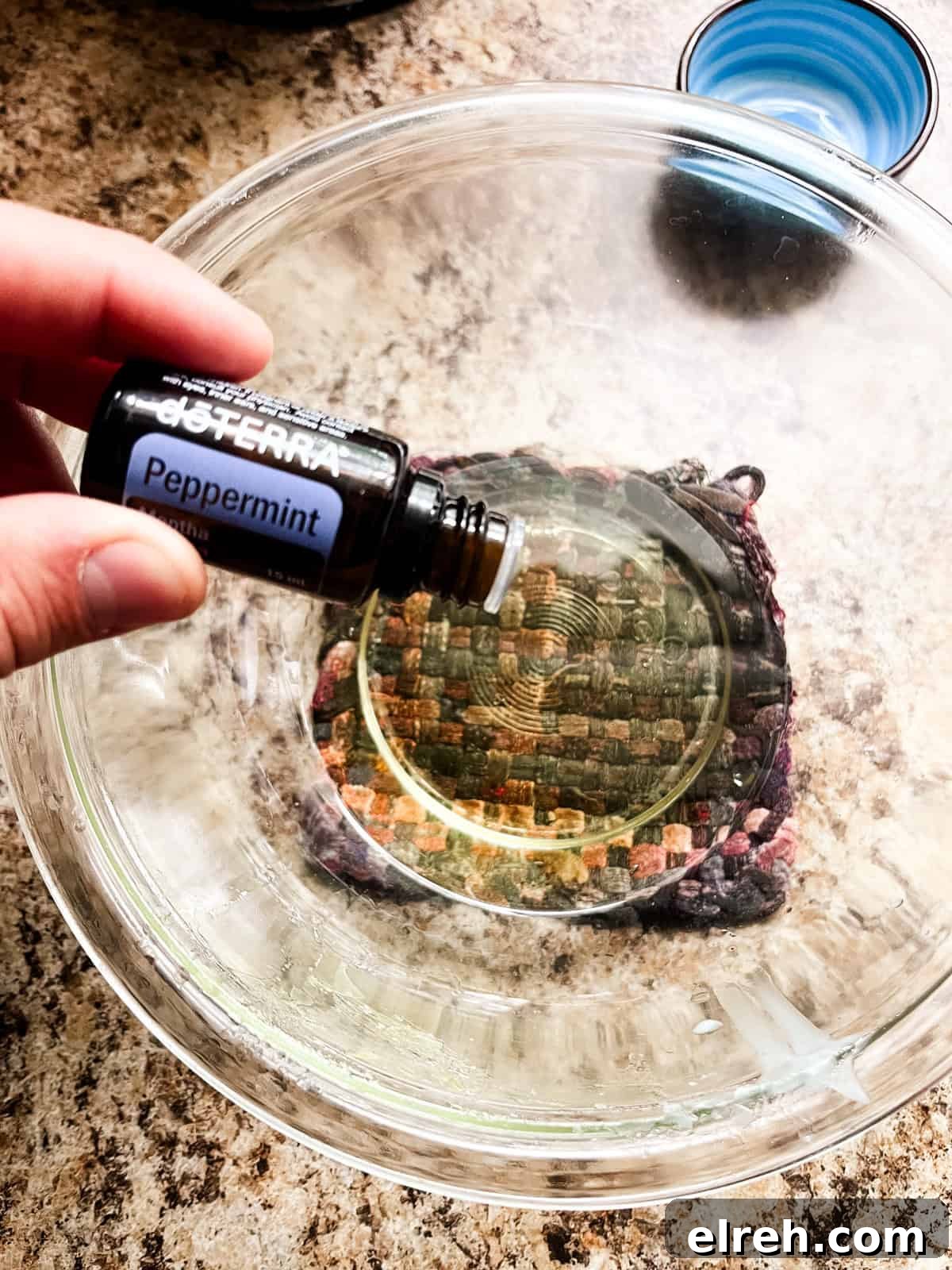 How to Make Tallow Lip Balm for Soft, Hydrated Lips 5 Dropping essential oils into a melted bowl of tallow lip balm ingredients.