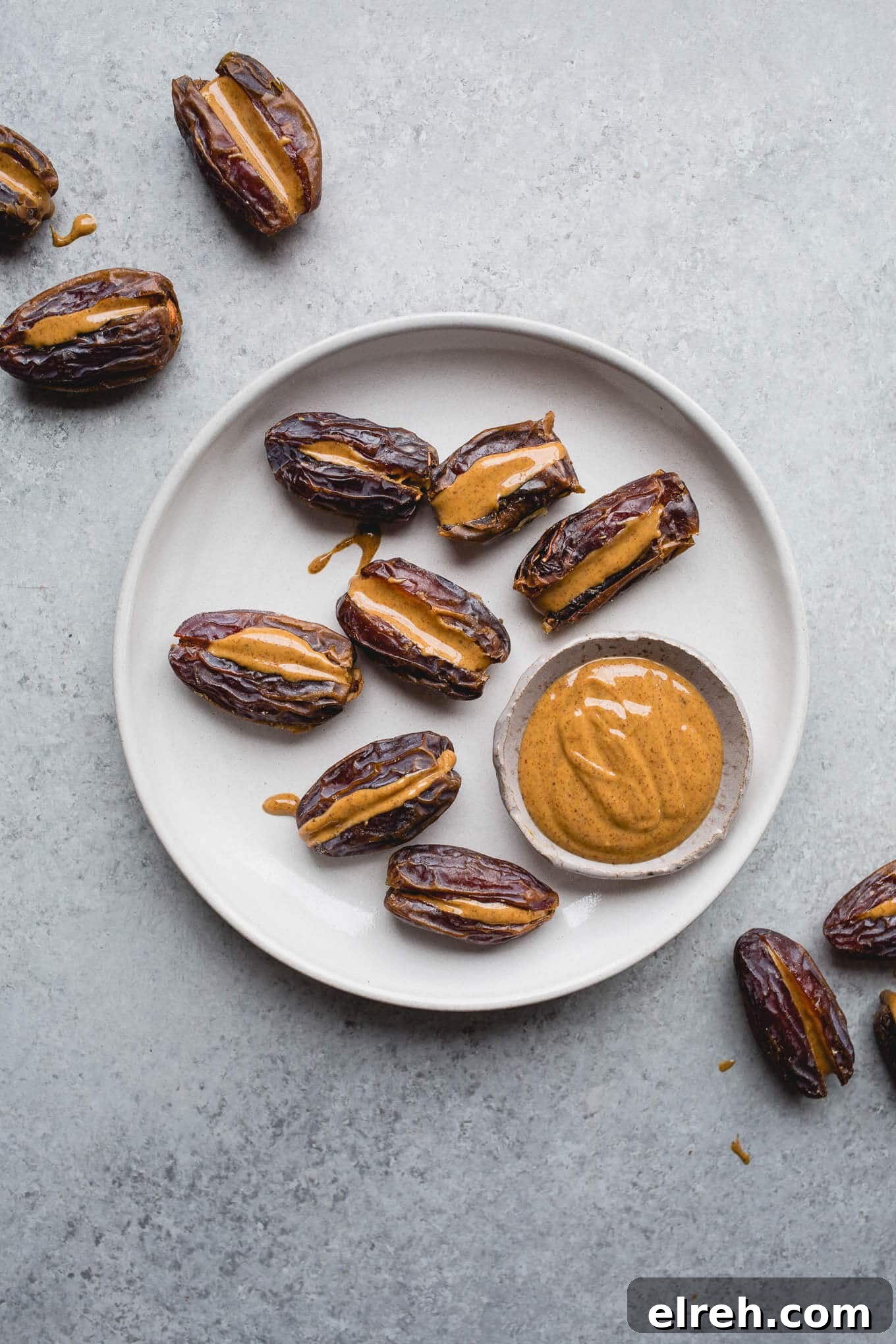 Almond butter stuffed dates on a plate.