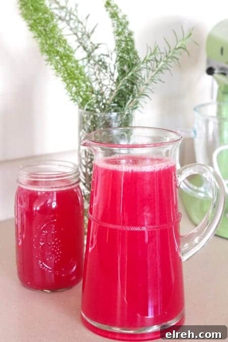 Refreshing Summer Drink Recipes to Beat the Heat 8 A clear pitcher of blueberry lemonade next to a full glass.