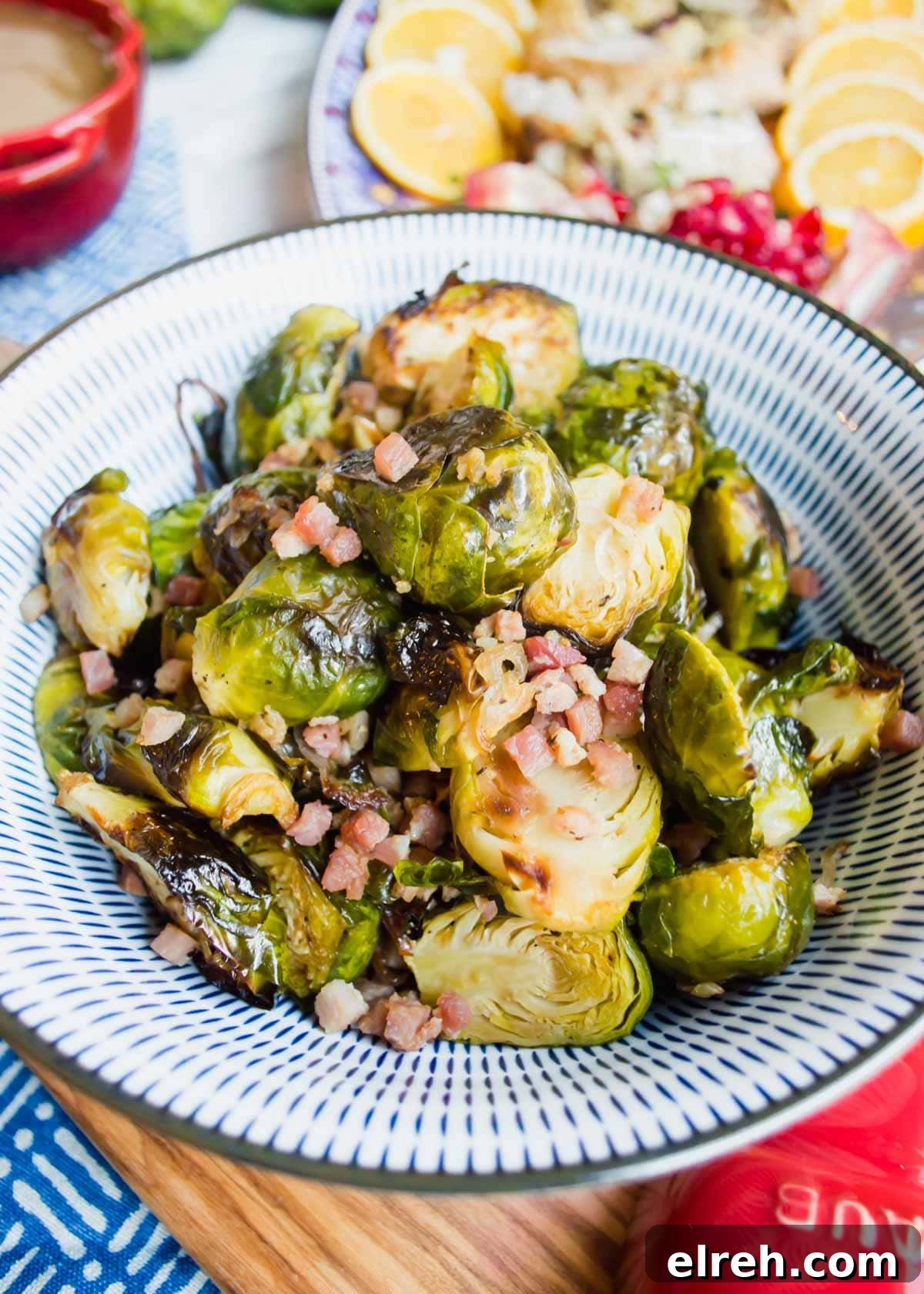22 Delicious Sides to Serve with Chicken Wings 11 Maple Brussel Sprouts with Pancetta in bowl flatlay.