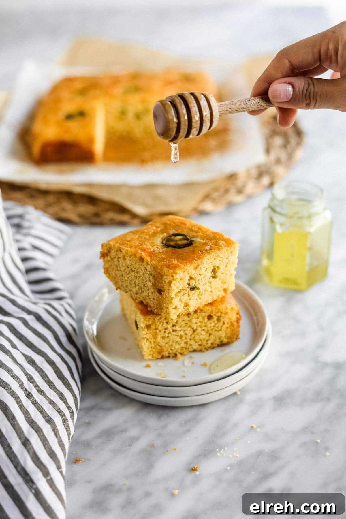 22 Delicious Sides to Serve with Chicken Wings 12 Jalapeño Cheddar Cornbread with Miso sliced on plate with butter and honey.