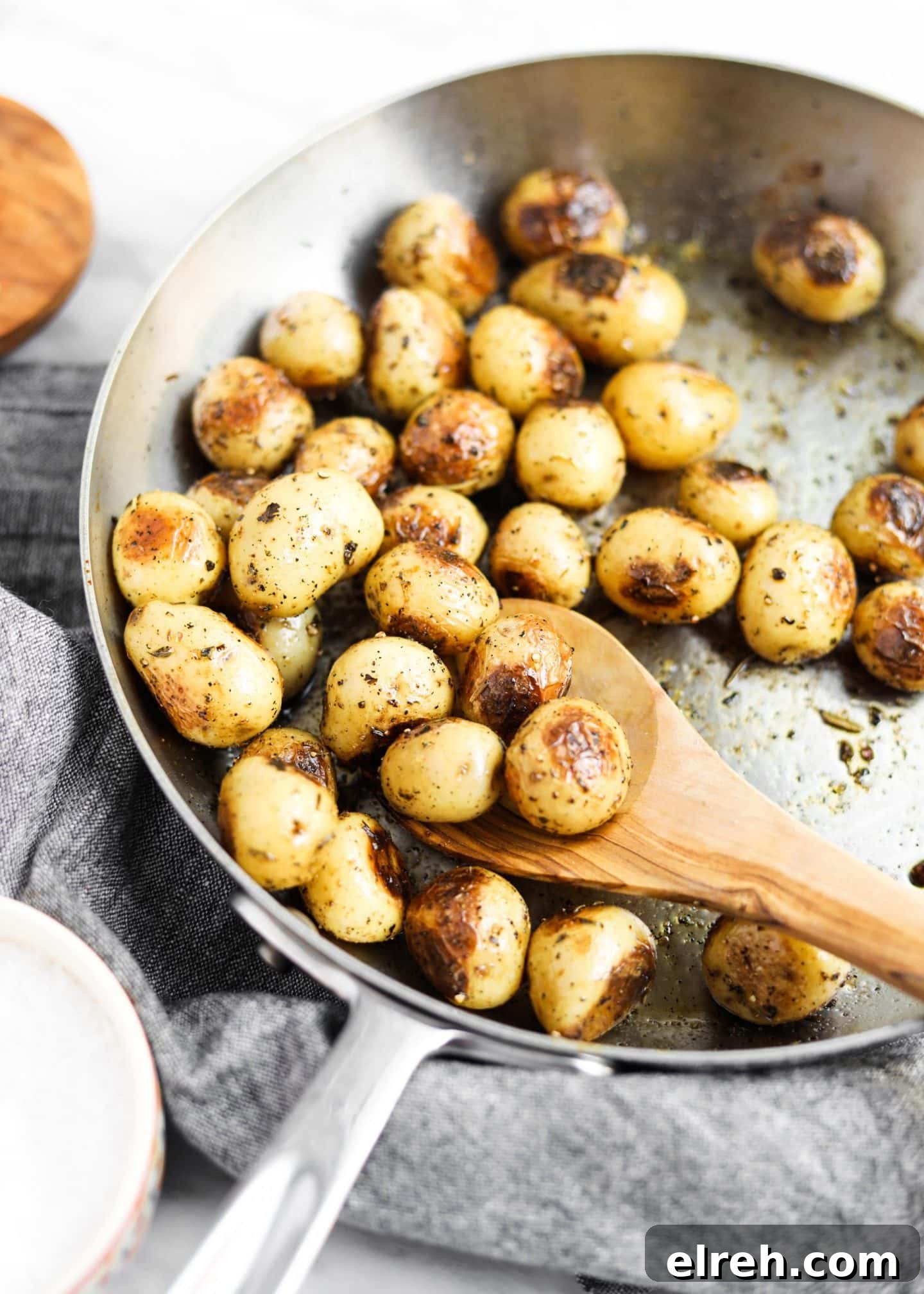 22 Delicious Sides to Serve with Chicken Wings 13 potatoes roasting in a pan with spoon