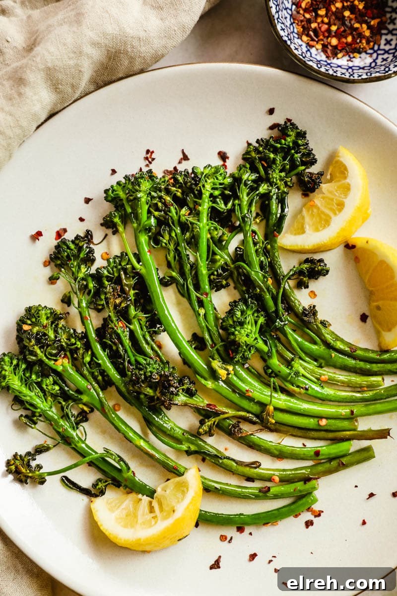 22 Delicious Sides to Serve with Chicken Wings 14 Easy delicious charred broccolini/broccoletti on a plate with seasoning, lemon wedges, and chili flakes.