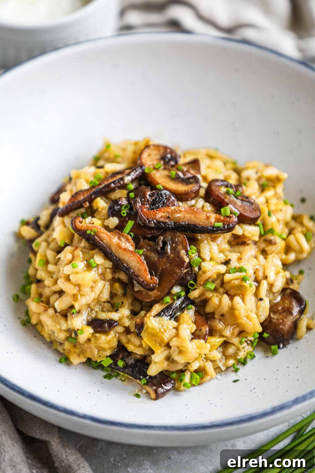 22 Delicious Sides to Serve with Chicken Wings 16 truffle mushroom leek risotto in a bowl with sautéed crimini and shiitake mushrooms on top.