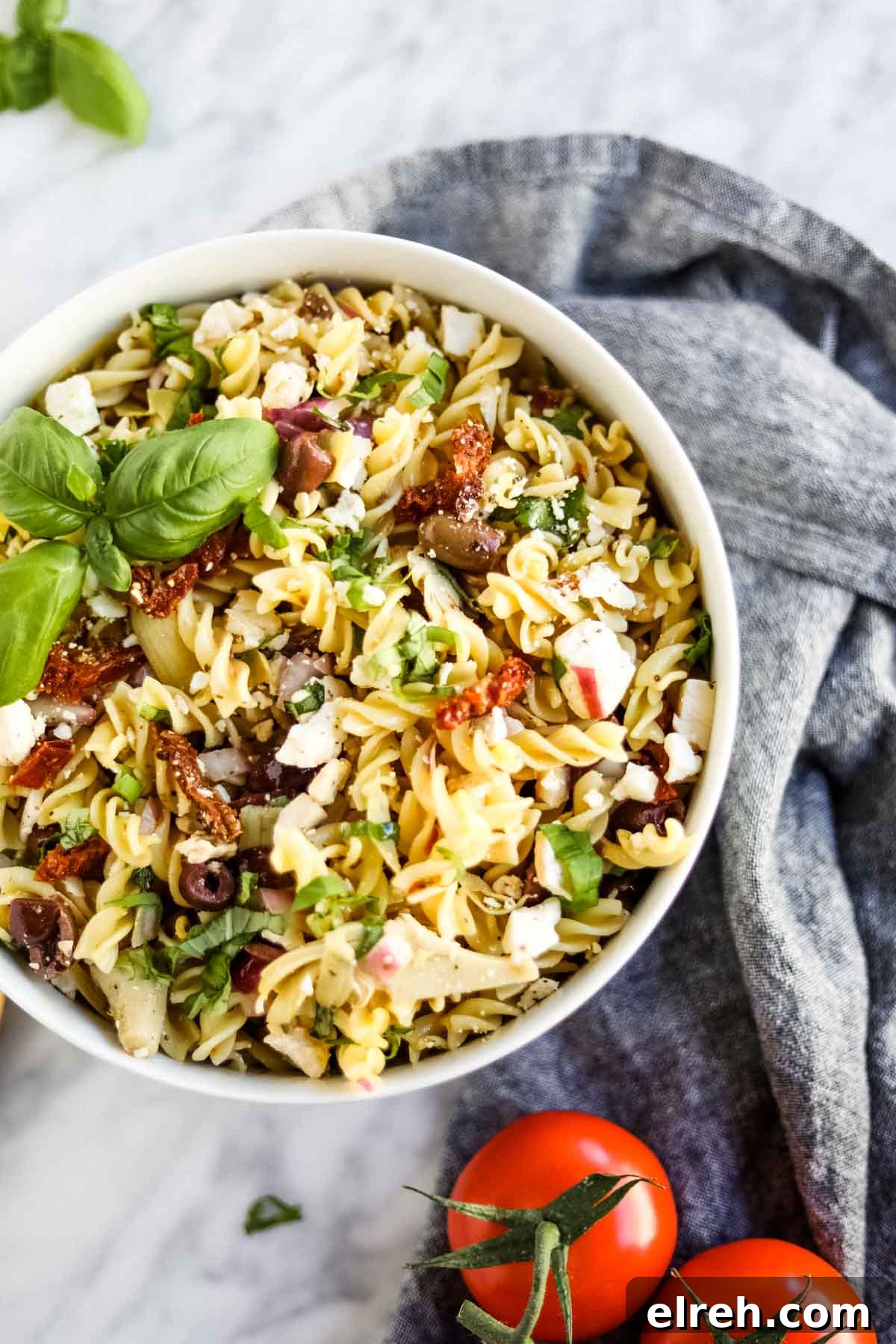 22 Delicious Sides to Serve with Chicken Wings 5 Pasta salad with Italian ingredients in bowl flatlay.