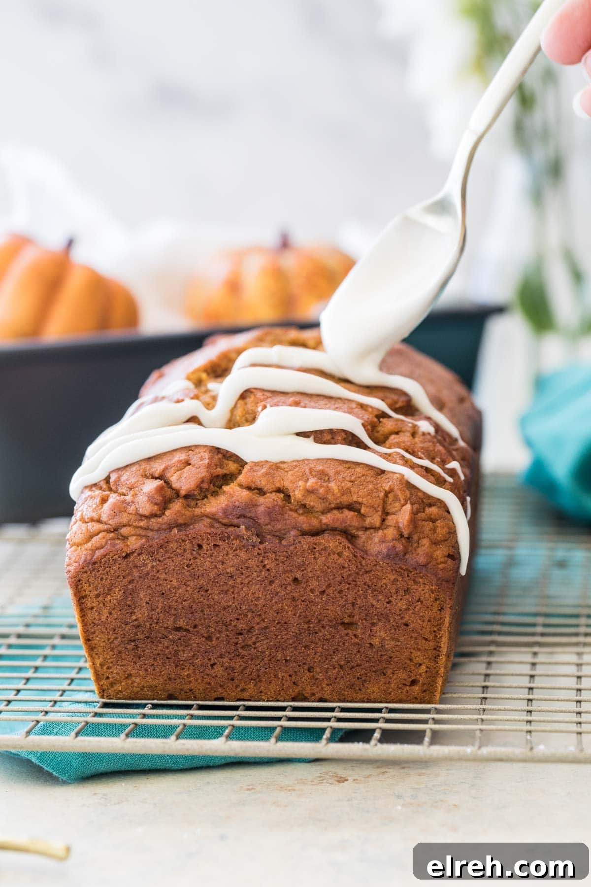 drizzling glaze over pumpkin loaf