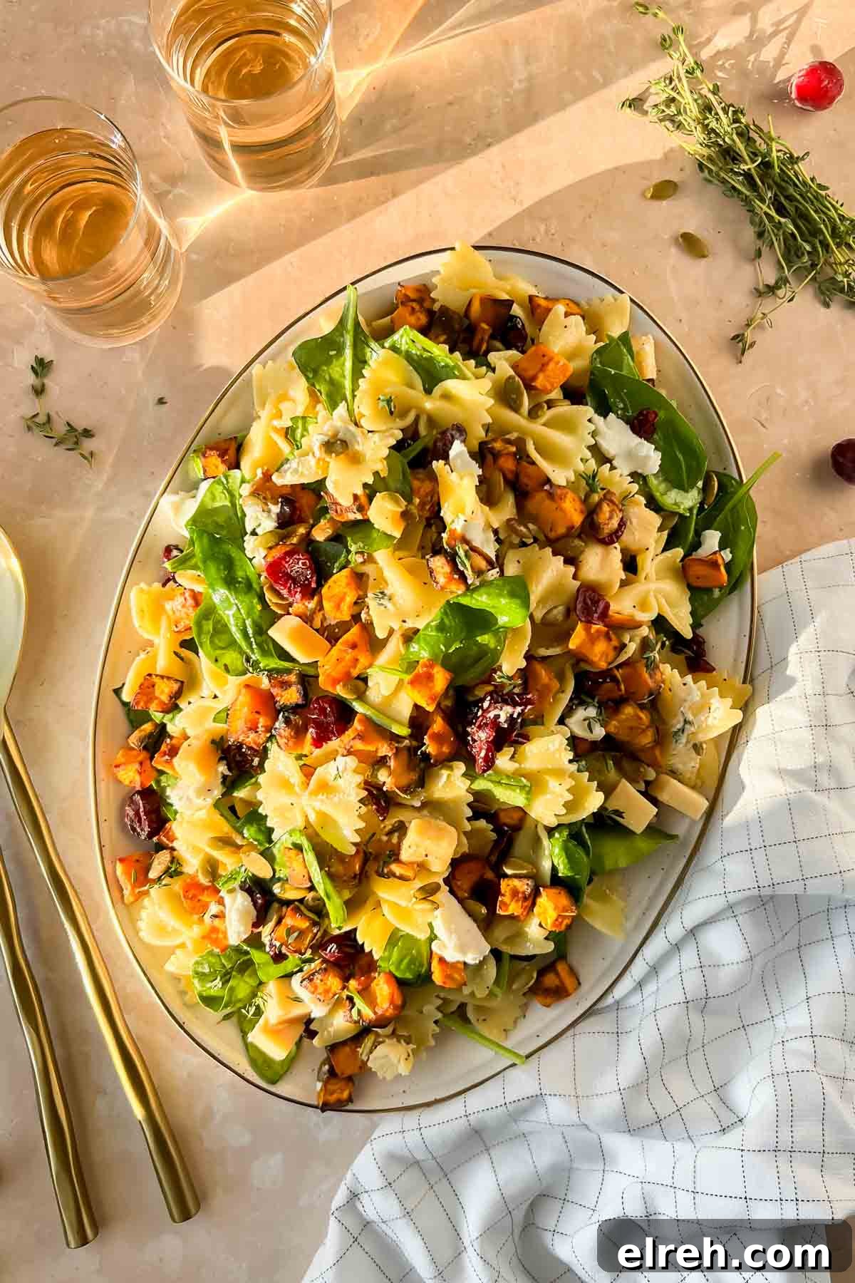 Fall Pasta Salad with Roasted Butternut, Cranberries and Feta 10 Fall pasta salad tossed and plated on white serving tray.