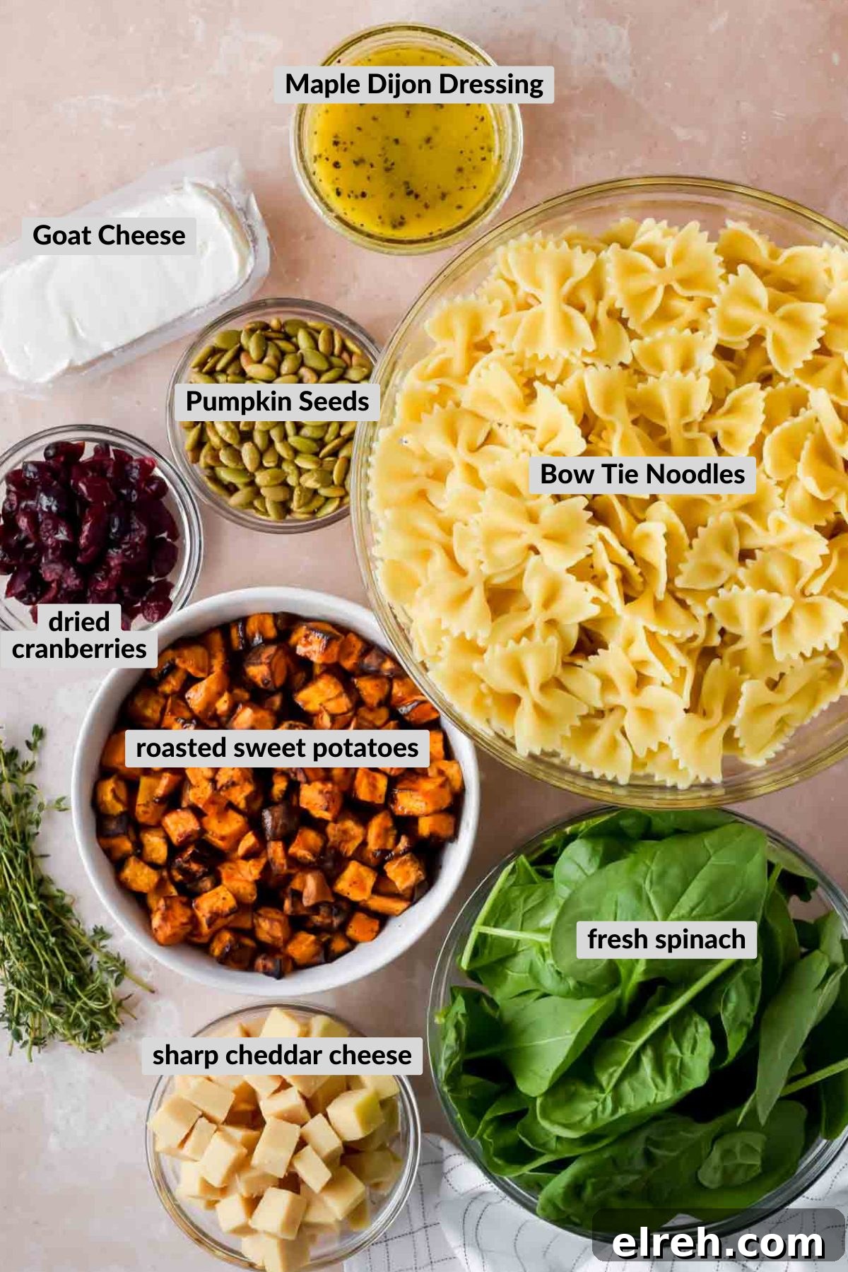 Fall Pasta Salad with Roasted Butternut, Cranberries and Feta 3 labeled ingredients for fall pasta salad in individual bowls.