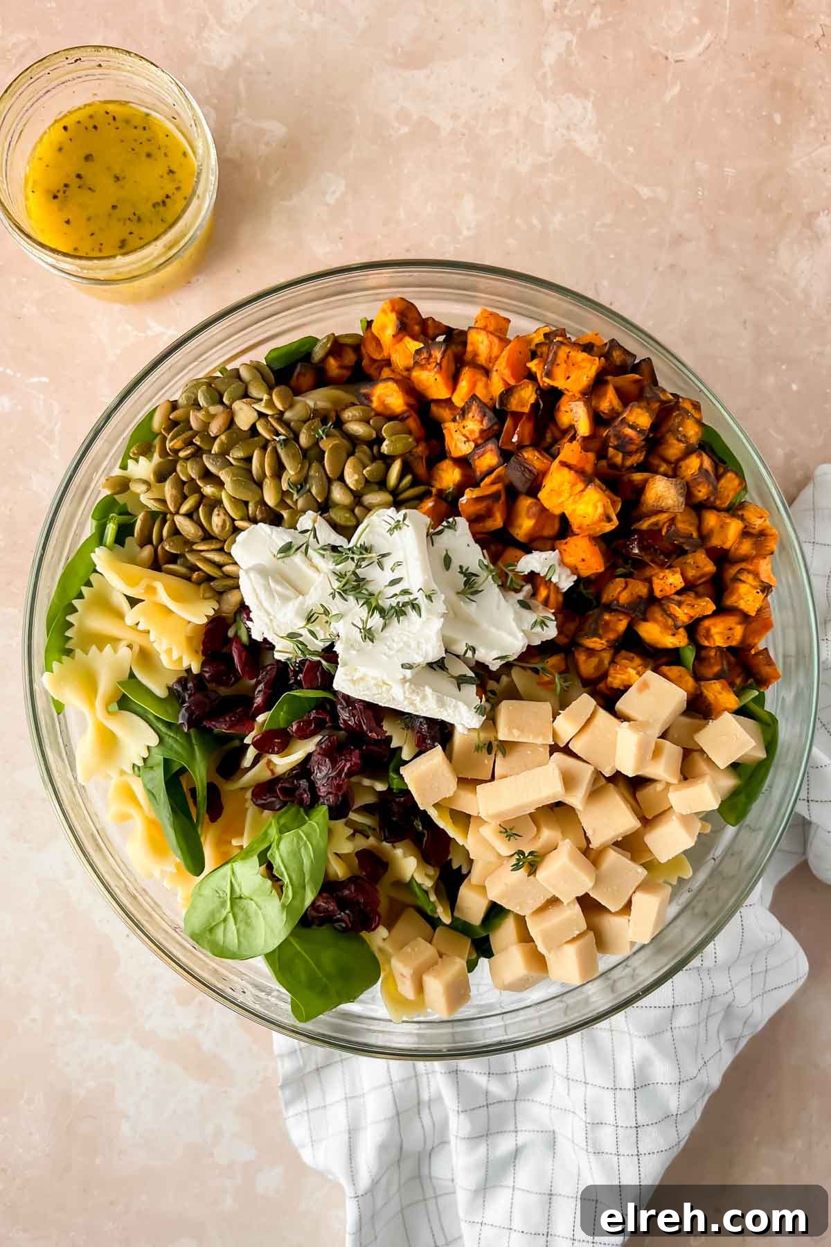 Fall Pasta Salad with Roasted Butternut, Cranberries and Feta 7 Fall pasta salad ingredients in glass mixing bowl before tossing.