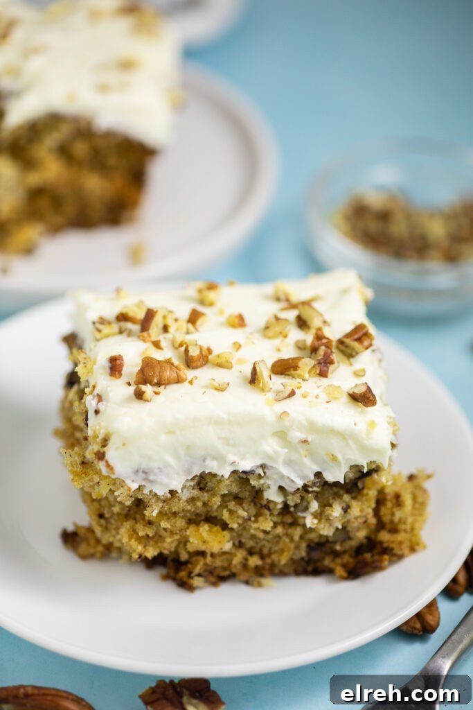 Classic Preacher Cake Recipe 2 Preacher Cake topped with cream cheese frosting and chopped pecans on a small white plate.
