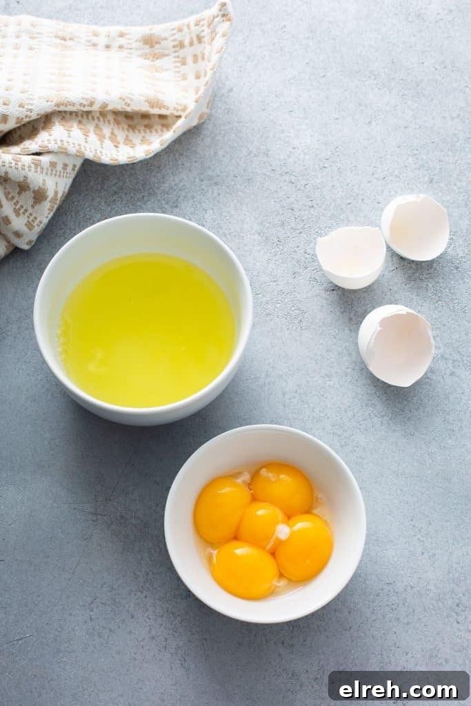 Egg whites and egg yolks in separate small bowls