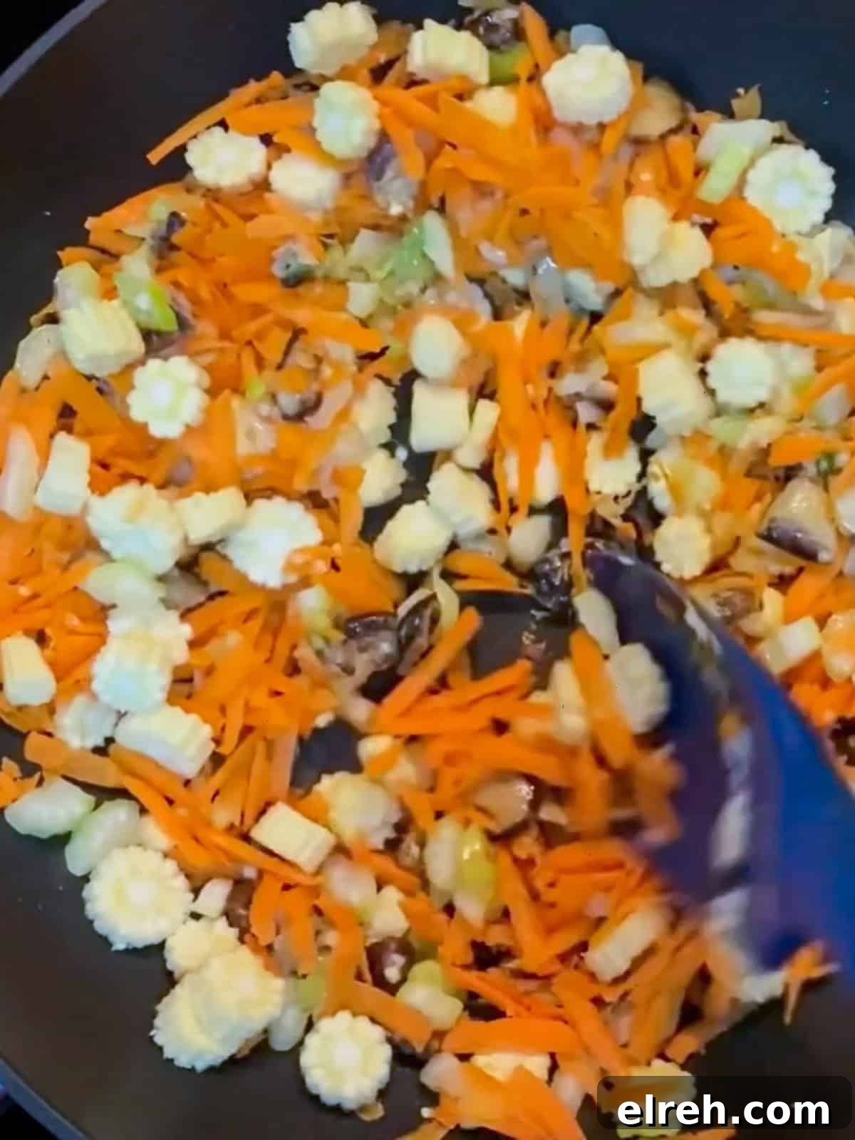Vegan San Choy Bau Lettuce Cups 7 Photo of stir-frying vegan san choy bau after carrot, baby corn and celery added.