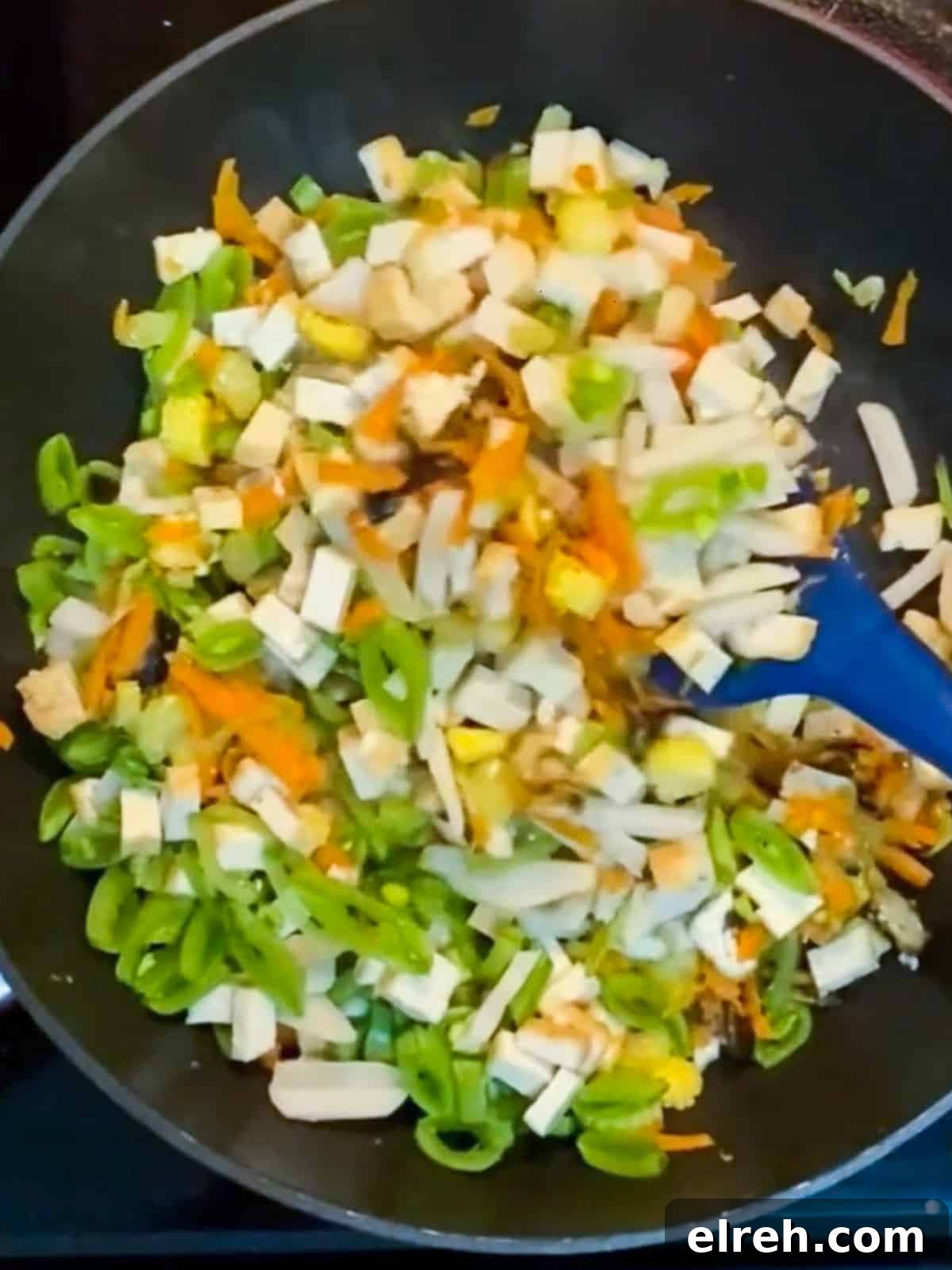 Vegan San Choy Bau Lettuce Cups 8 Photo of stir-frying vegan san choy bau after tofu and water chestnuts added.
