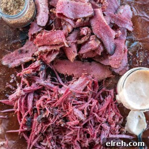 a pile of sliced and pulled beef brisket pastrami.