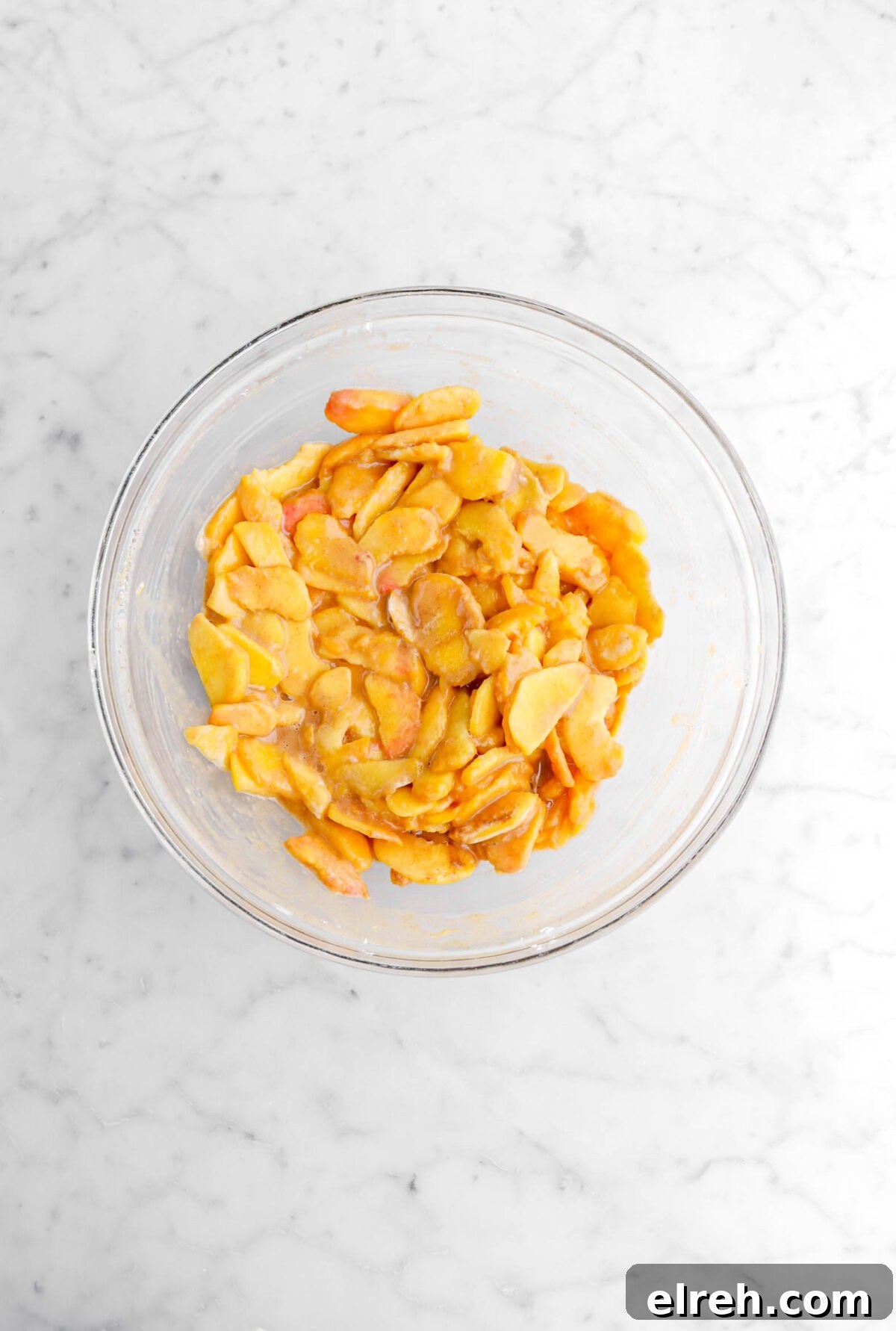 Peach Cobbler Crisp with Brown Sugar and Cinnamon 13 peaches mixed with spices in glass bowl