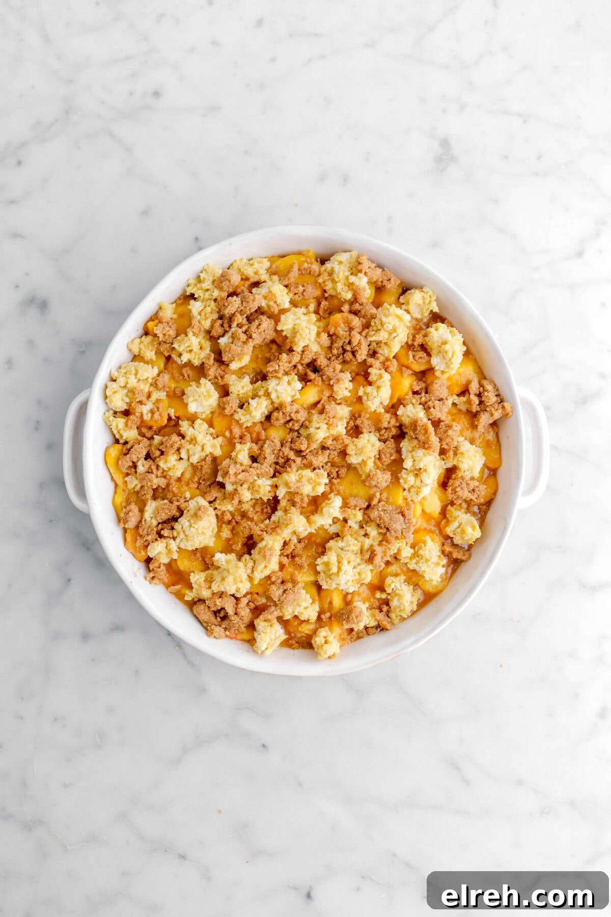 Peach Cobbler Crisp with Brown Sugar and Cinnamon 17 streusel added on top of peach mixture.