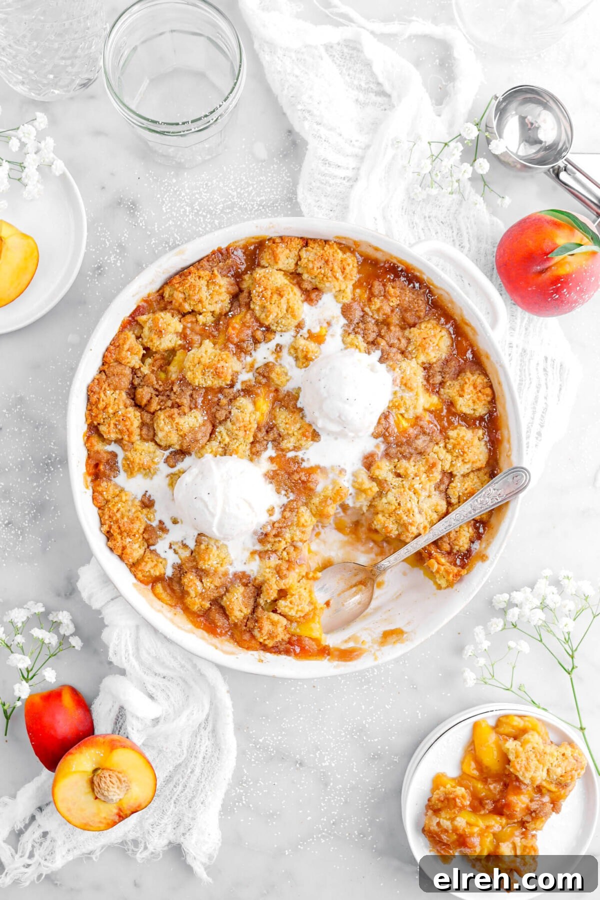 Peach Cobbler Crisp with Brown Sugar and Cinnamon 20 peach cobbler with spoon dug into bottom right of cobbler with a serving of cobbler on small white plate beide.
