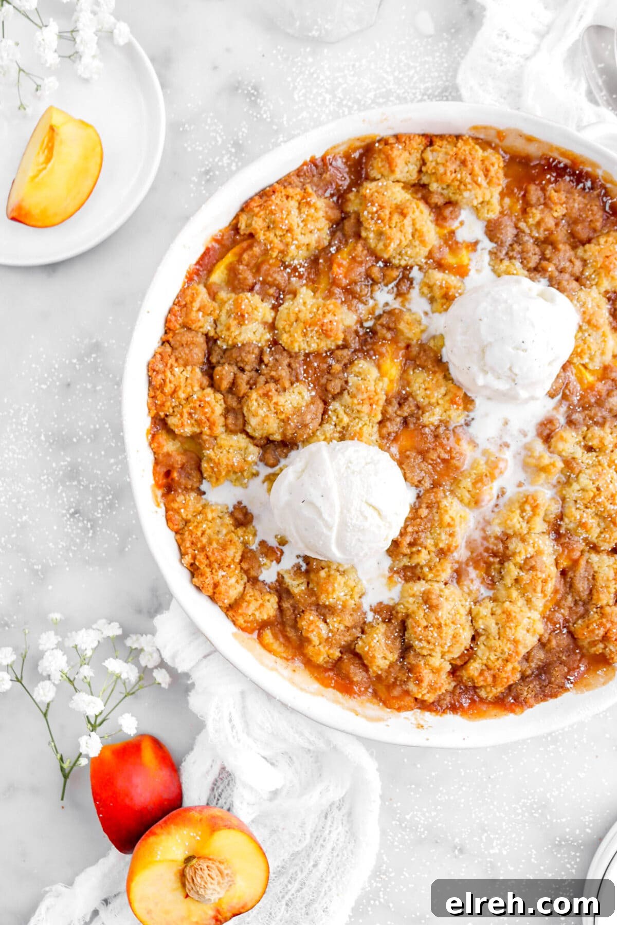 Peach Cobbler Crisp with Brown Sugar and Cinnamon 5 cropped overhead shot of peach cobbler with two scoops of melting ice cream on top.