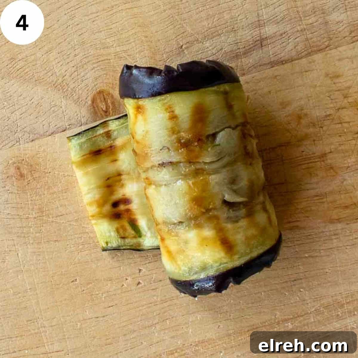 A slice of grilled eggplant rolled up.