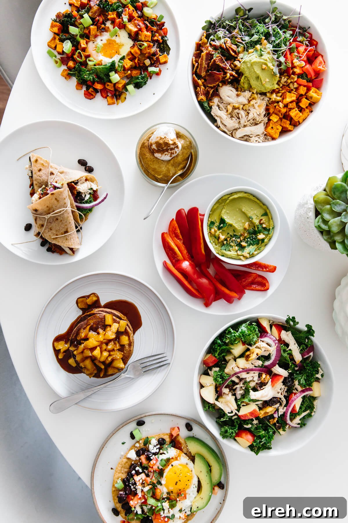 Several plates of meal prepped food on a table.