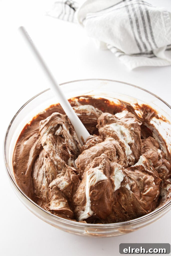 Irish Coffee Chocolate Cake Recipe 4 A bowl of mousse with whip cream being folded in