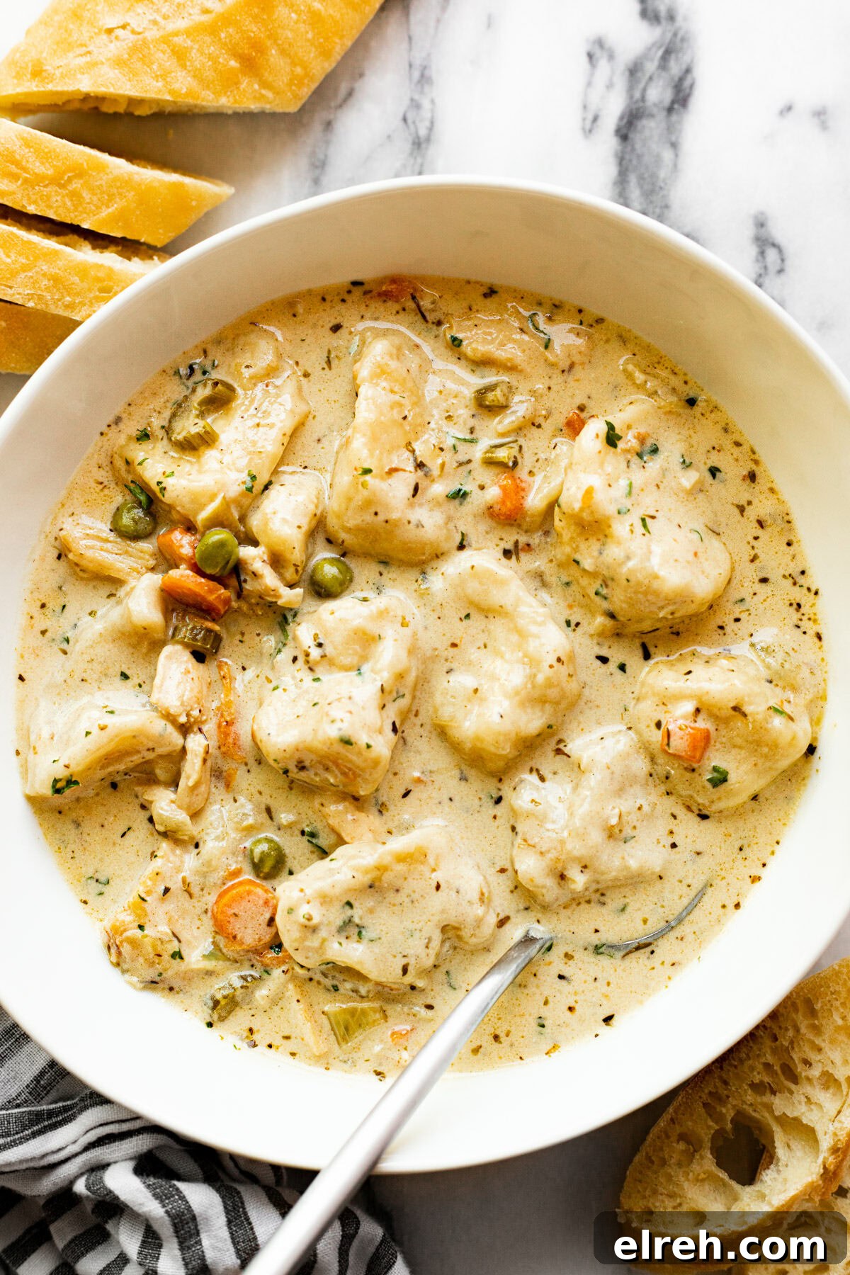 White bowl filled with homemade chicken dumpling soup.