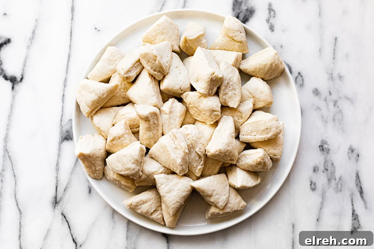 White plate with chopped refrigerated biscuit dough.