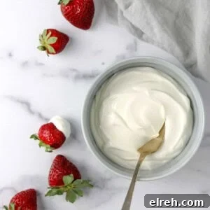 Whipped Vanilla Cream Skyr in a bowl next to strawberries.