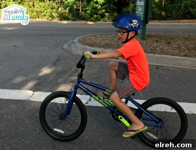 Stiff Baby Syndrome How to Help a Hypertonic Child 5 A little boy wearing a helmet and riding a bicycle.