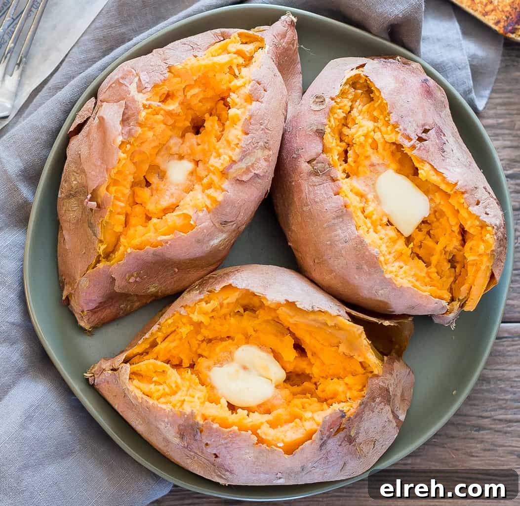 overhead shot of microwaved sweet potatoes with butter on a green earthenware plate