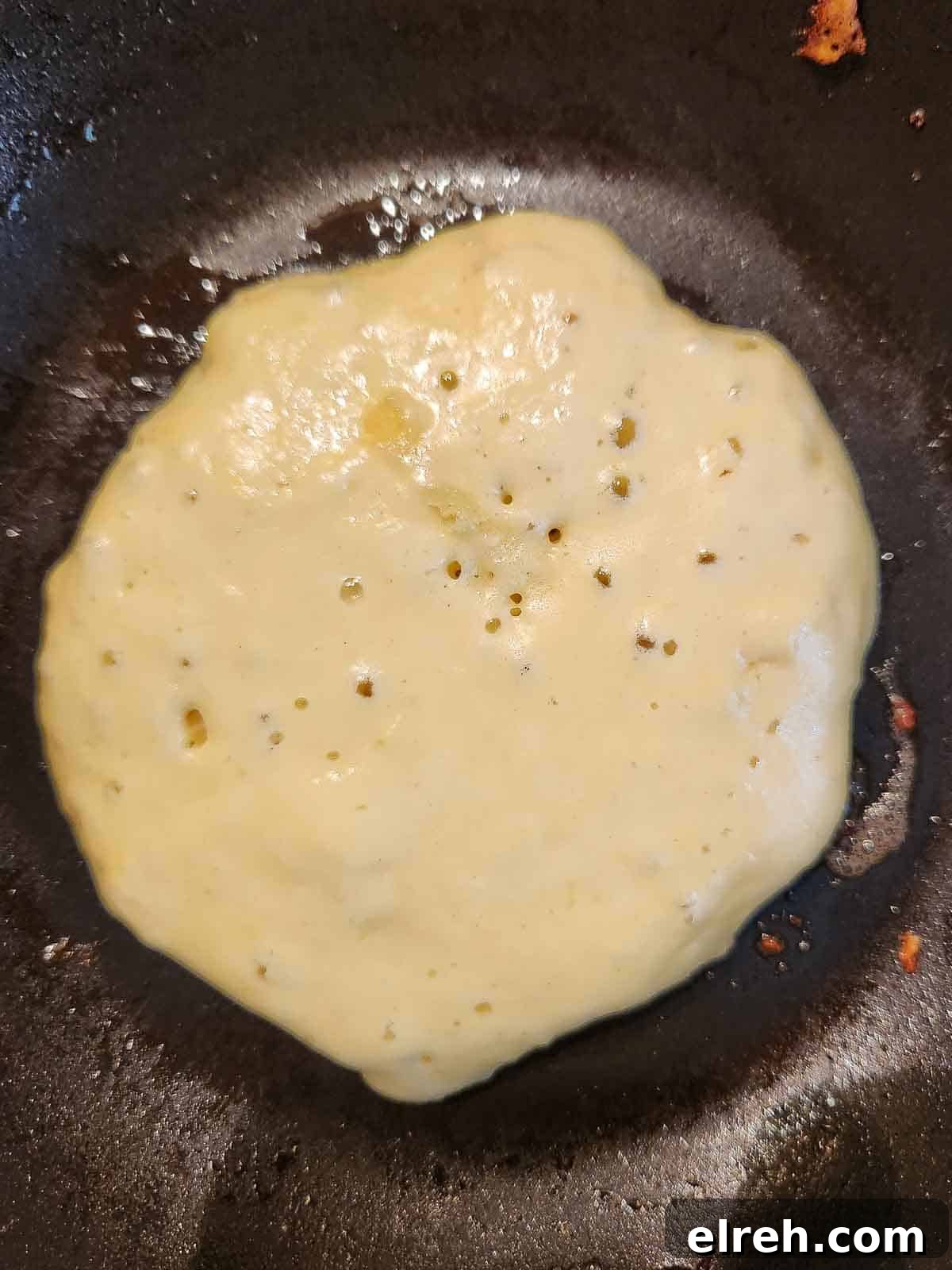Fluffy Sweet Cream Cinnamon Pancakes Recipe 6 Pancake batter in a skillet being cooked.
