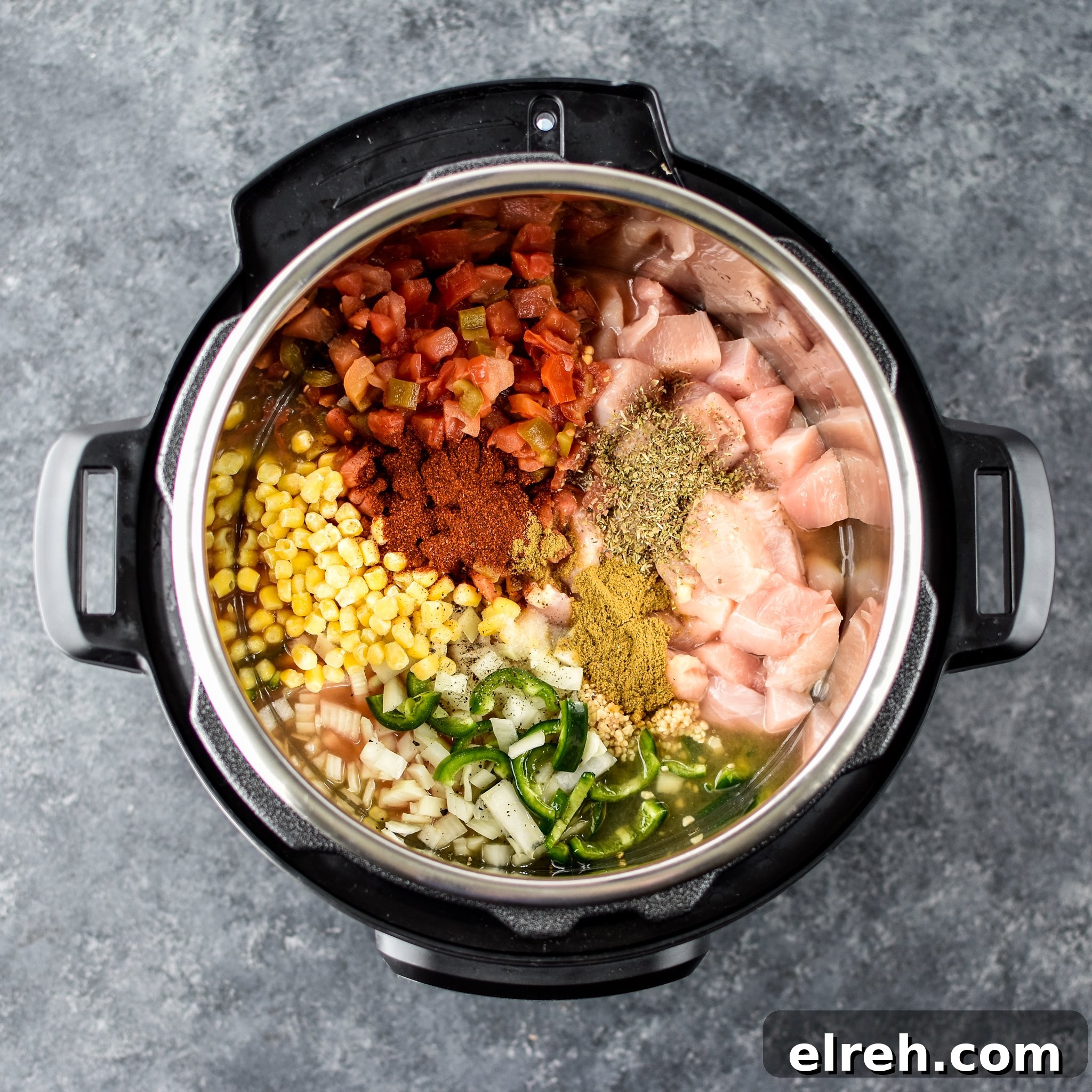 A view of the ingredients for the Instant Pot Jalapeno Popper chicken Soup inside the Instant Pot from above.