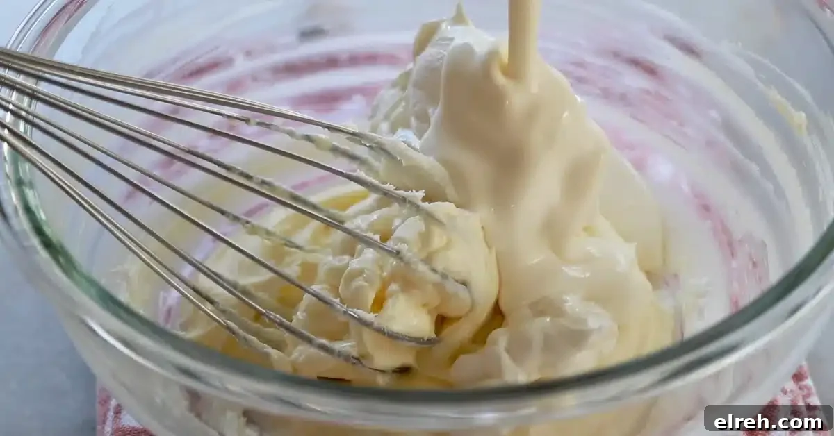Mini Strawberry Cheesecake Bites Recipe 11 adding sour cream and heavy cream to a bowl