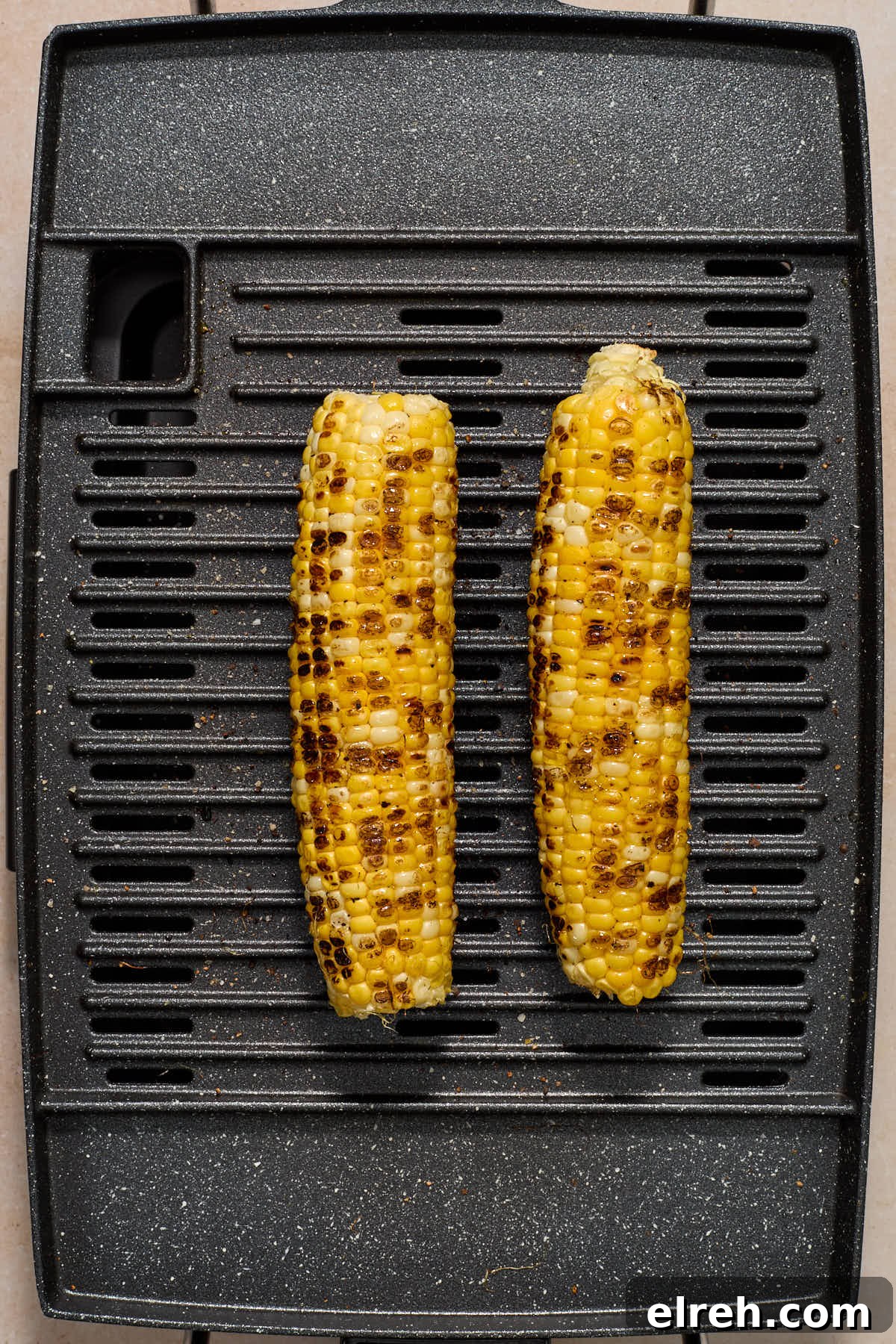 Grilled Vegetable Orzo Salad with Summer Peaches 6 Charred ears of corn on a grill.