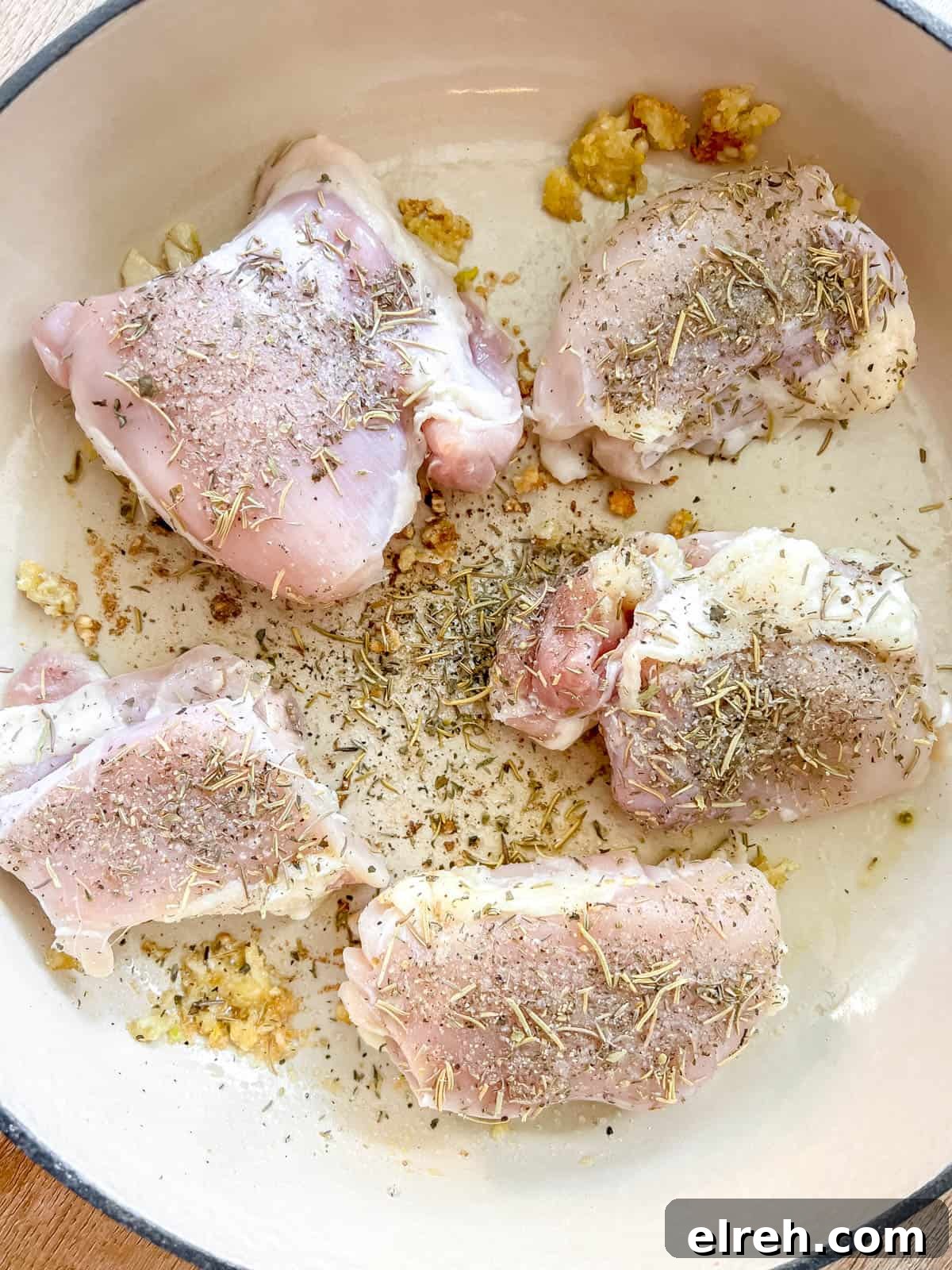Maple Peach Chicken Thighs in a Dutch Oven 7 Chicken thighs added to a pan.