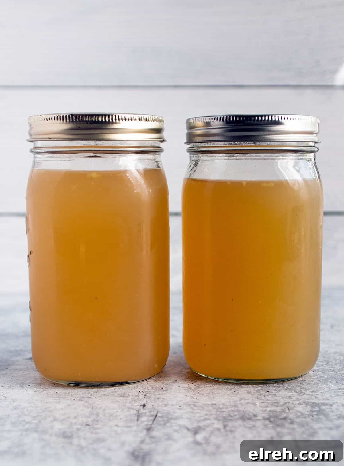 Two large mason jars with homemade turkey broth.